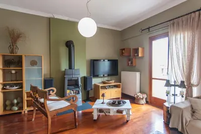 a living room with a couch and a tv at Sea view maisonette in Chania Town