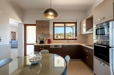 a kitchen with a glass table with a bowl on it at Soleado apartment in Chania Town