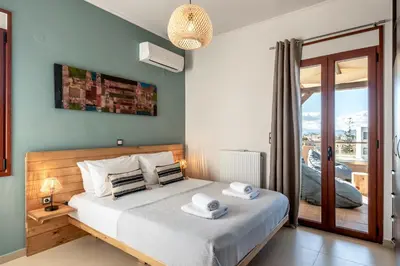 a bedroom with a bed with towels on it at Soleado apartment in Chania Town