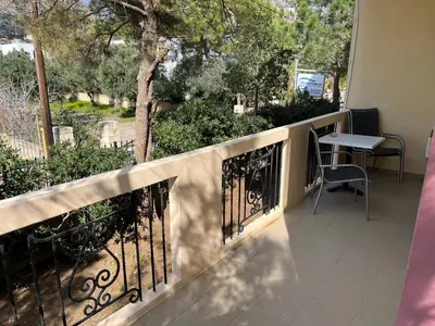 a balcony with a fence and a table and chairs at Mediterranean Sea Down Floor in Palaiochóra
