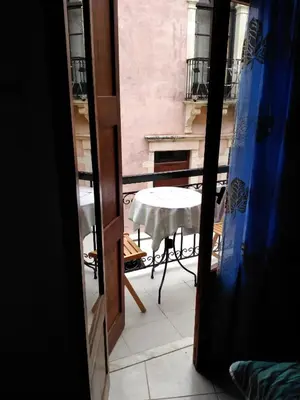 a view from a window of a table and a balcony at Smaragdi in Chania Town