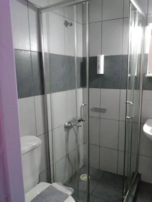 a bathroom with a shower with a toilet and a sink at Smaragdi in Chania Town