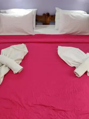 two beds with red sheets and white pillows at Smaragdi in Chania Town