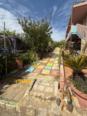 a street with a rainbow painted on the ground at Modern 1-bedroom with BBQ & Roof Garden near Beach in Stalos