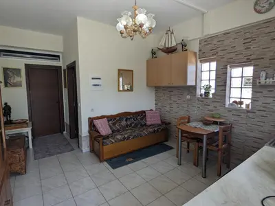 a living room with a couch and a table at Modern 1-bedroom with BBQ & Roof Garden near Beach in Stalos
