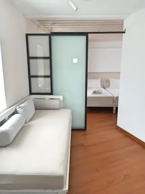 a living room with a white couch and a bed at Hotel Amphora in Chania Town