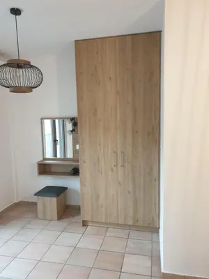 a large wooden cabinet in a room with a tile floor at To Ellinikon in Omalós