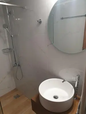 a bathroom with a white sink and a mirror at To Ellinikon in Omalós