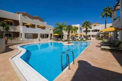 a large swimming pool in front of a building at Toxo Hotel in Plataniás