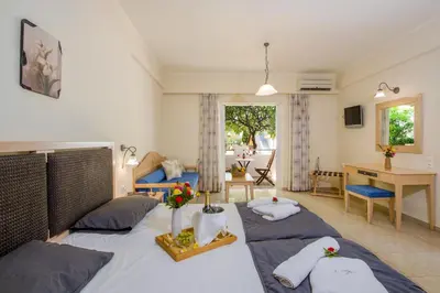 a bedroom with a bed with two pillows and a desk at Toxo Hotel in Plataniás