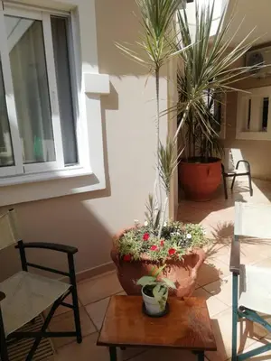 a living room with a large vase with flowers on a table at Toxo Hotel in Plataniás
