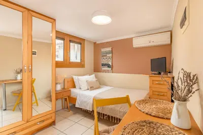 a small room with a bed and a television at Lidra Rooms in Chania Town