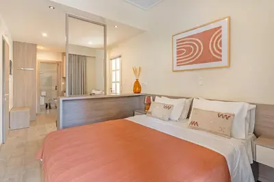a bedroom with a large bed in a room at Lidra Rooms in Chania Town
