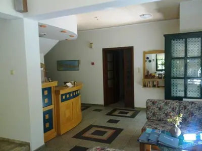 a living room with a couch and a table at Rea Hotel in Palaiochóra