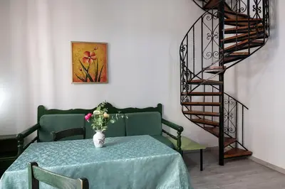 a dining room with a table with a vase of flowers at Anastasia Apartments in Chania Town
