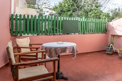 a table and chairs on a patio with a fence at Anastasia Apartments in Chania Town