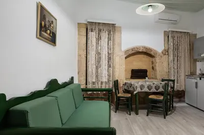 a living room with a green couch and a table at Anastasia Apartments in Chania Town
