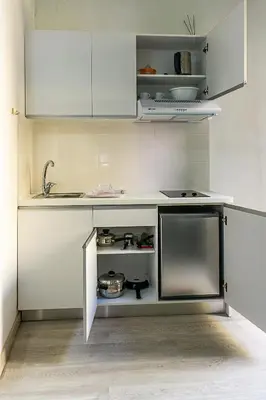 a kitchen with white cabinets and a sink at Anastasia Apartments in Chania Town