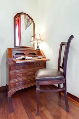 a desk with a chair and a mirror at Casa Leone Hotel in Chania Town