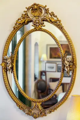 an ornate gold mirror hanging on a wall at Casa Leone Hotel in Chania Town