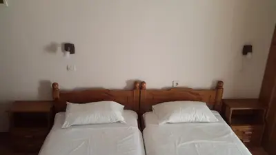 two beds sitting next to each other in a bedroom at Stelios Rooms in Palaiochóra