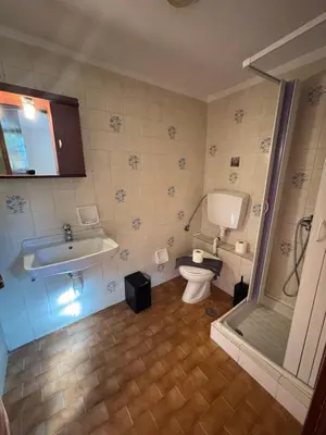 a bathroom with a tub and a toilet and a sink at Stelios Rooms in Palaiochóra