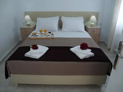 a bedroom with a bed with two roses on it at Brigitte house in Chania Town