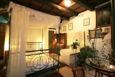 a room with a balcony with a tub and a table at Ifigenia Traditional Rooms & Maisonettes in Chania Town