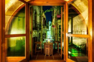 a window with a view of a table and chairs at Ifigenia Traditional Rooms & Maisonettes in Chania Town