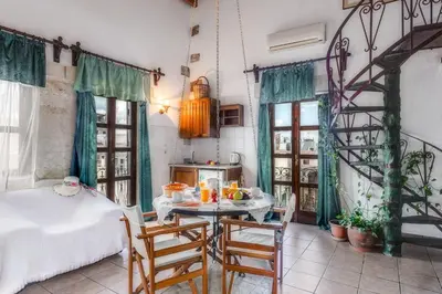 a kitchen with a table and chairs in a room at Ifigenia by Captain Michalis in Chania Town