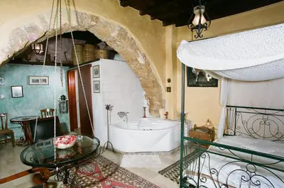 a bathroom with a tub and a glass table at Ifigenia by Captain Michalis in Chania Town