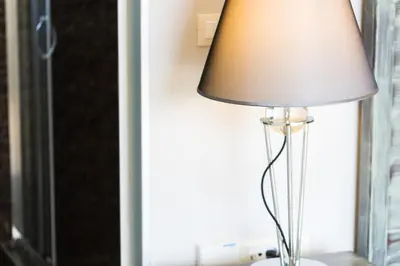 a lamp sitting on a table next to a window at Rodi Stone Villa in Kalyves