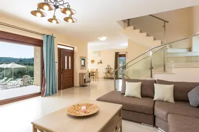a living room with a couch and a table at Rodi Stone Villa in Kalyves