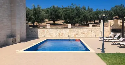 a swimming pool in the middle of a patio at Levanda Luxury Stone Villa in Kalyves