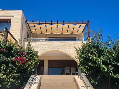 a building with a balcony with stars on it at Levanda Luxury Stone Villa in Kalyves