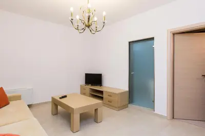 a living room with a couch and a table at Levanda Luxury Stone Villa in Kalyves