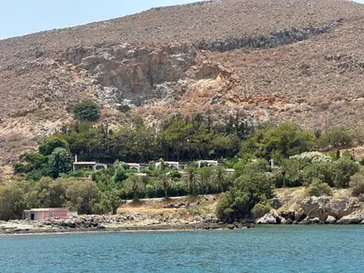 a house on the shore of a body of water at Villas Vista Del Mar in Kissamos