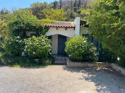 a house with a door and some bushes at Villas Vista Del Mar in Kissamos