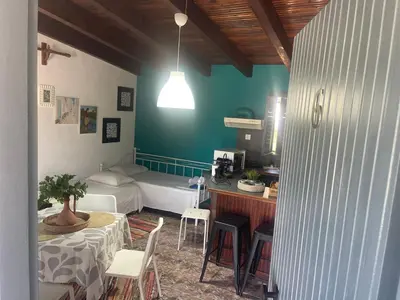 a room with a bed and a table and chairs at Villas Vista Del Mar in Kissamos
