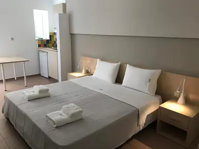 a bedroom with a large bed with towels on it at Kleanthi Studios in Chania Town