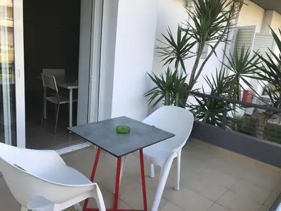 a table and chairs on a balcony with plants at Kleanthi Studios in Chania Town