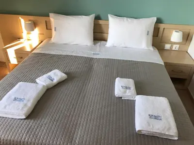a bedroom with a bed with towels on it at Kleanthi Studios in Chania Town