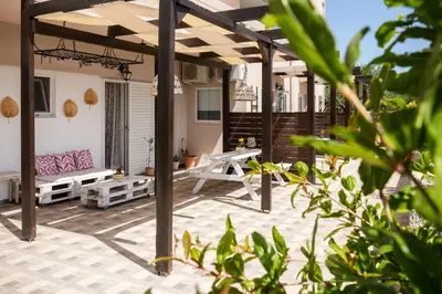 a patio with a bench and a table at EvaEle Luxury Boutique in Kissamos