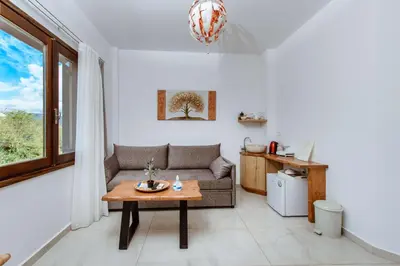 a living room with a couch and a table at Deluxe Suites in Chania Town