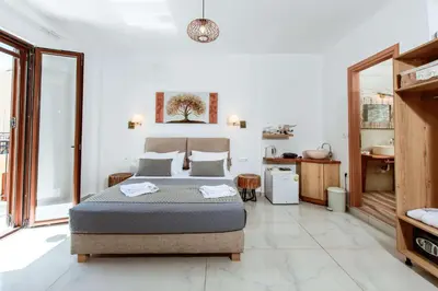 a bedroom with a bed and a bathroom at Deluxe Suites in Chania Town