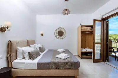a bedroom with a bed and a balcony at Deluxe Suites in Chania Town