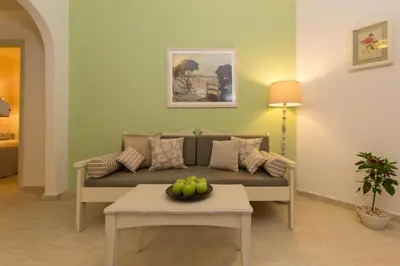 a living room with a couch and a table at Agrimia Holiday Apartments in Plataniás