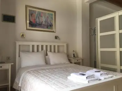a bedroom with a bed with towels on it at Sifis in Loutro