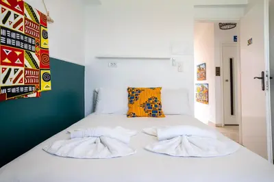 a bedroom with a white bed with two pillows at Kumba At Koum Kapi in Chania Town
