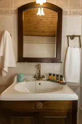 a bathroom with a sink and a mirror at Revellino del Porto, Historic Residence in Chania Town